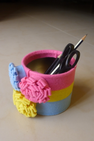 Tin can decorated with felt flowers